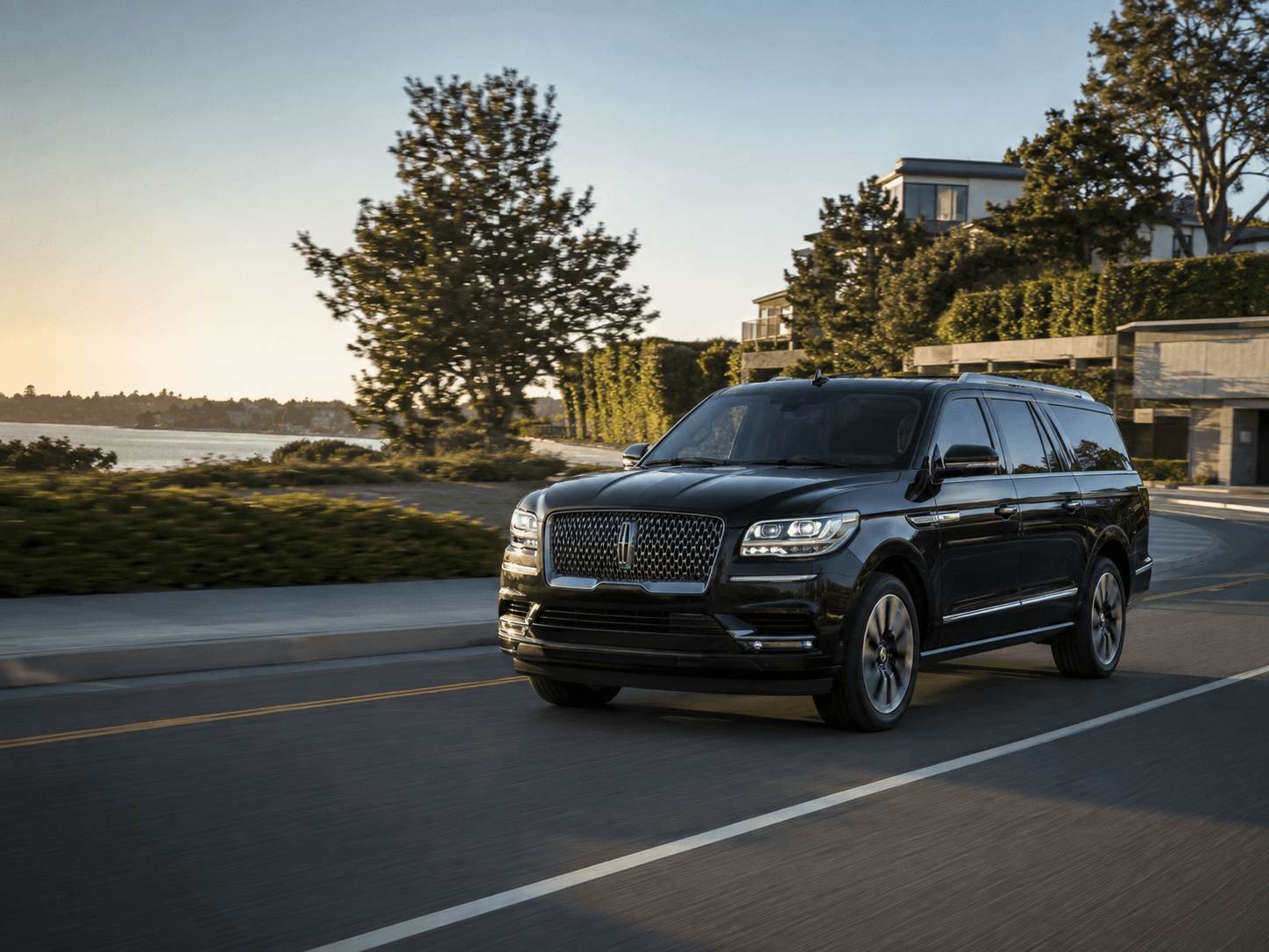 Black Lincoln Navigator traveling on a scenic road